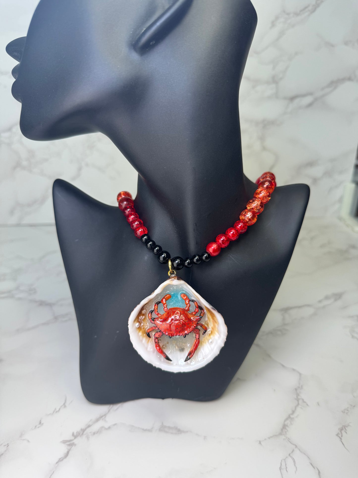Fire Tide Sentinel Natural seashell featuring a handmade craft metal red-and-black spotted crab. Beautiful semiprecious Stones Necklace