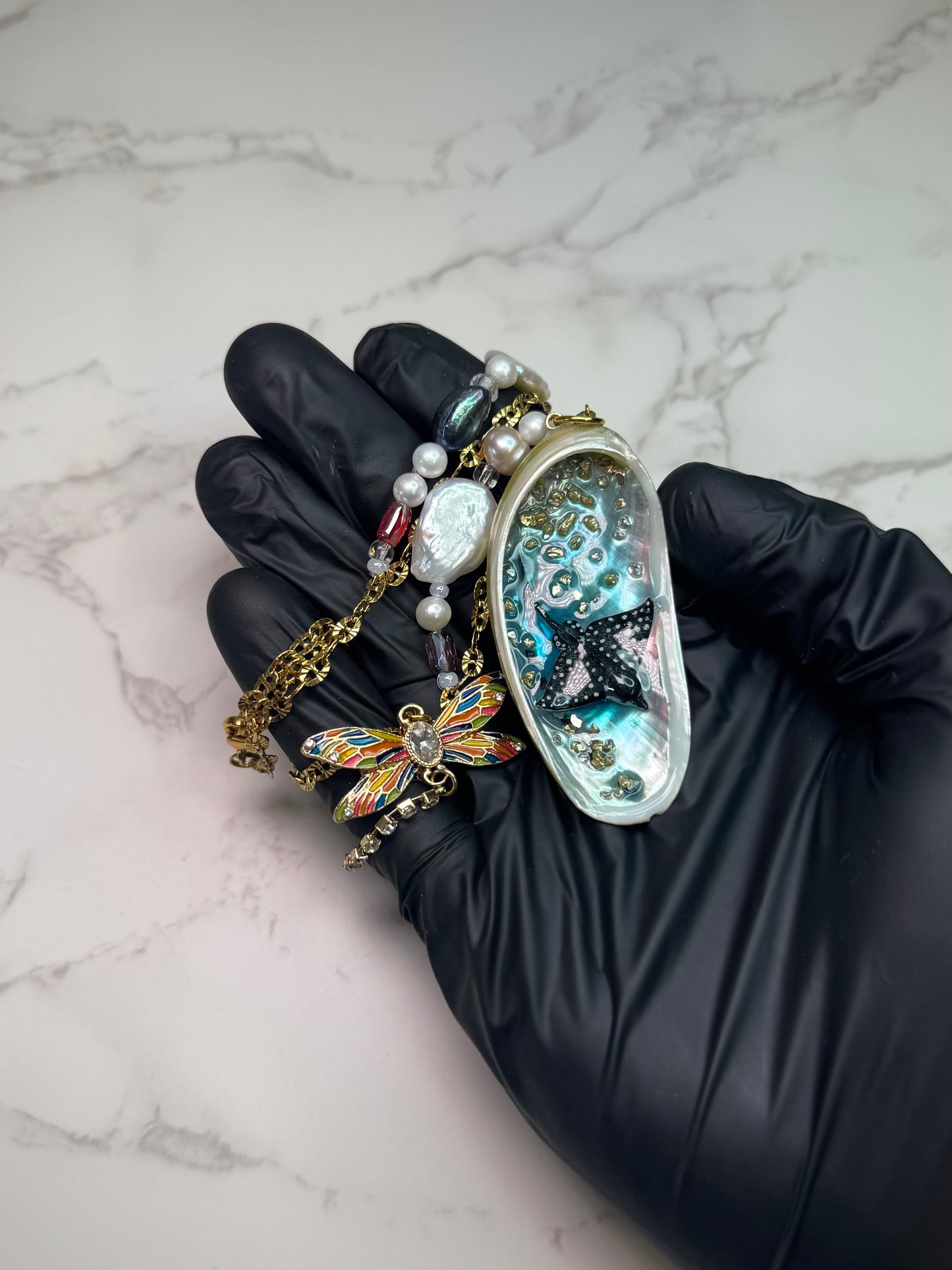 Starlit Reef Natural seashell featuring a miniature black-spotted manta ray and a gemmed dragonfly trinket encapsulated in clear UV resin
