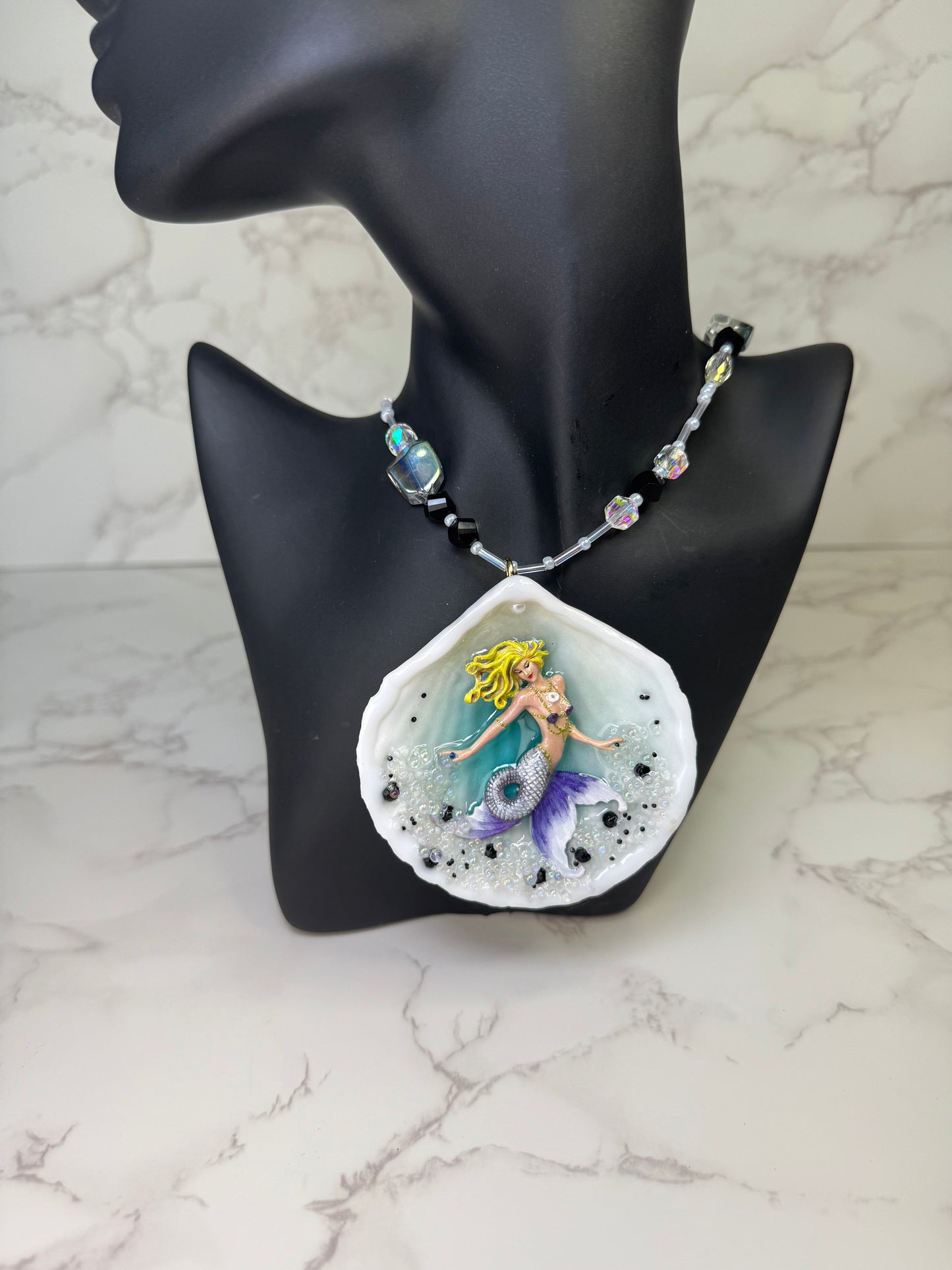 Lavender Tides Mermaid Natural seashell featuring a handmade crafted blonde mermaid with a white-and-purple shimmering tail encapsulated in clear UV resin Beauty Natural Necklace