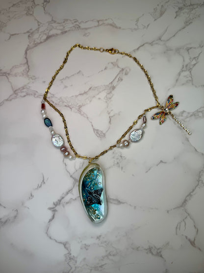 Starlit Reef Natural seashell featuring a miniature black-spotted manta ray and a gemmed dragonfly trinket encapsulated in clear UV resin