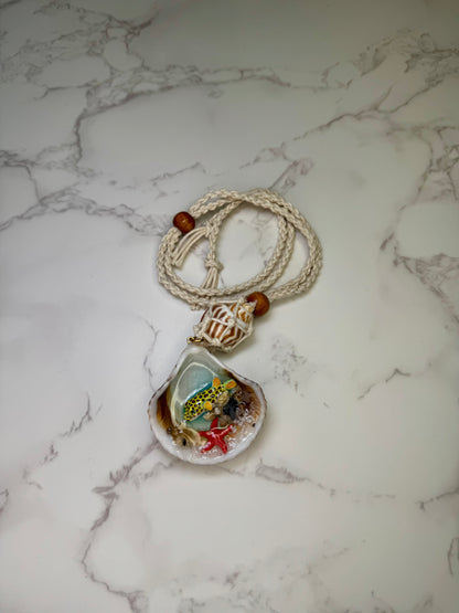 Sunny Shore Drift Natural seashell featuring a handmade metal yellow pufferfish with black spots, tiny red starfish, and delicate sand bits preserved in clear UV resin Beautiful corded necklace