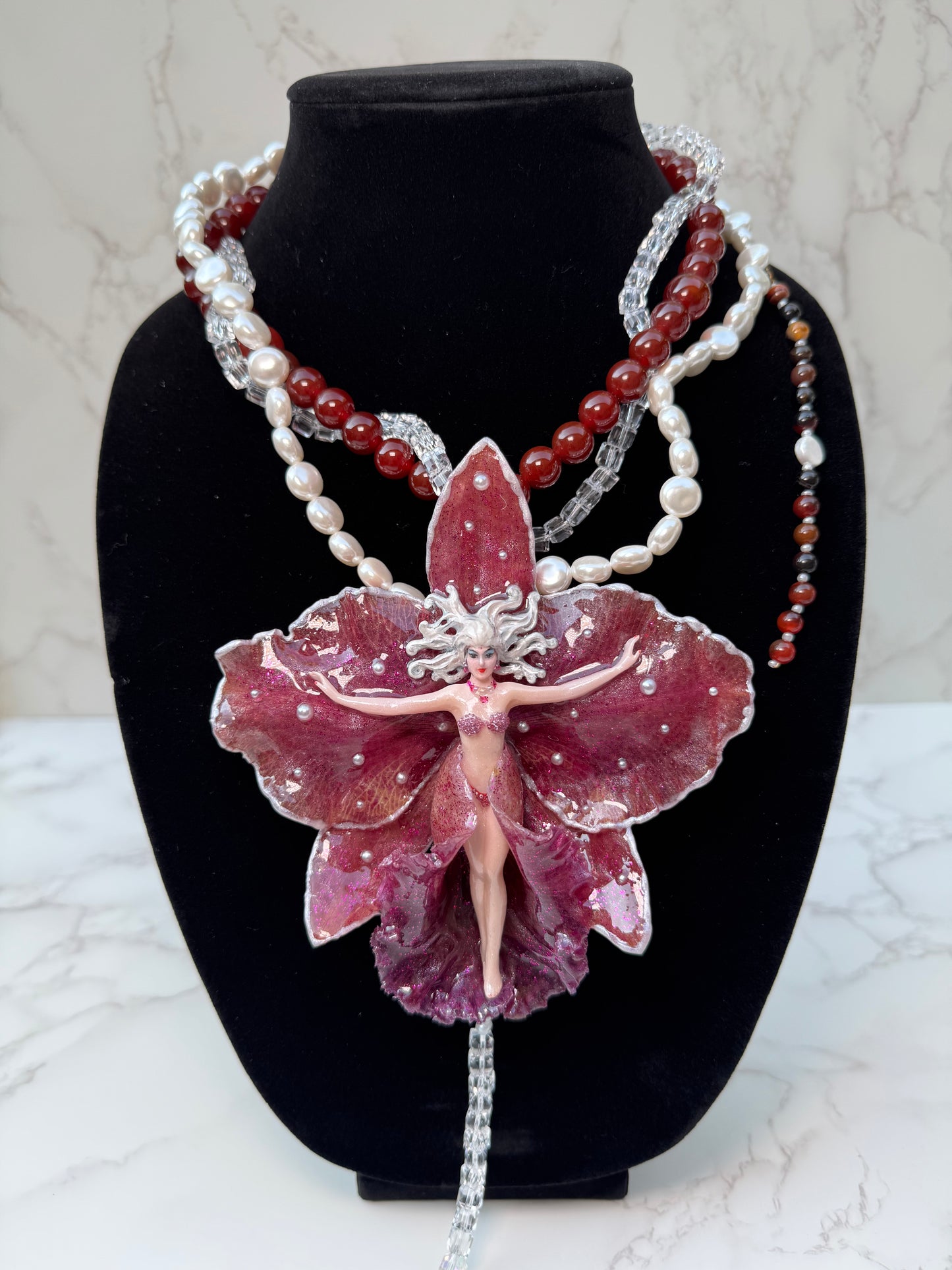 Calista – LIMITED EDITION – NYFW EXHIBITION PIECE Real Dark Purple Orchid with White Edges, Hand-Carved Female Figure, Mother-of-Pearl, Freshwater Pearls and Clear & Crimson Crystal Necklace