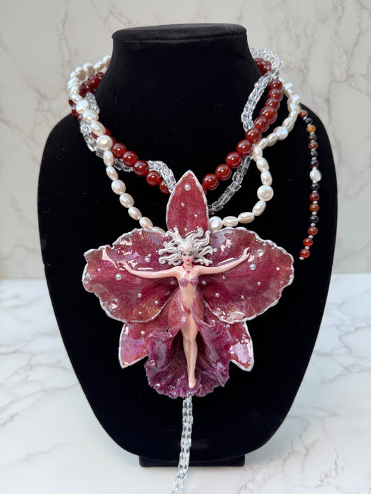 Calista – LIMITED EDITION – NYFW EXHIBITION PIECE Real Dark Purple Orchid with White Edges, Hand-Carved Female Figure, Mother-of-Pearl, Freshwater Pearls and Clear & Crimson Crystal Necklace